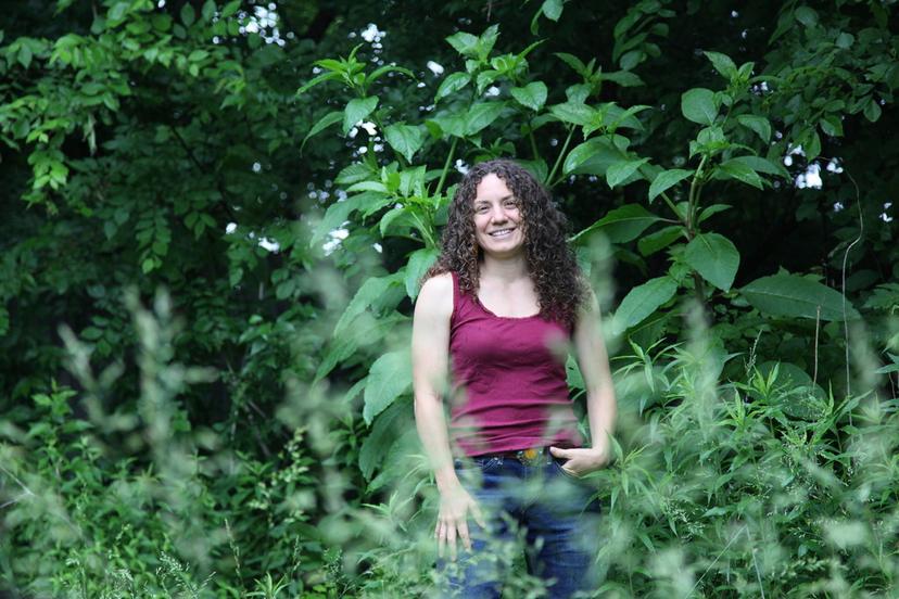 Amanda Beltranmini Healen stands among the plants in her backyard in Nashville, where she participates in No Mow Months to improve water retention and encourage pollinators