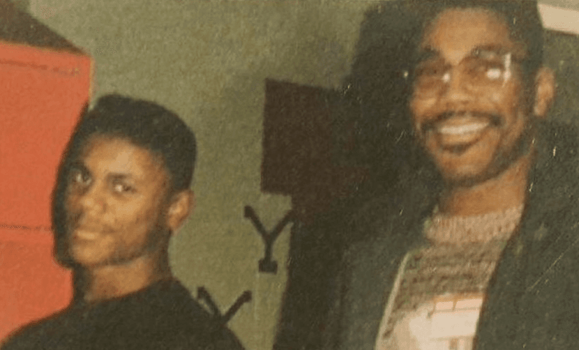 A young man and an older man, both smiling