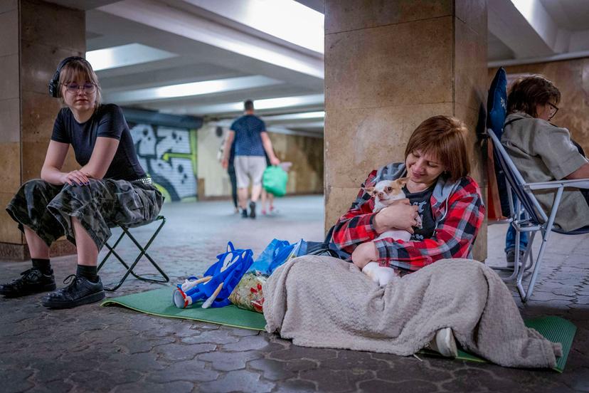 People hide in a metro station, being used as a bomb shelter, during a Russian drones attack in Kyiv, Ukraine