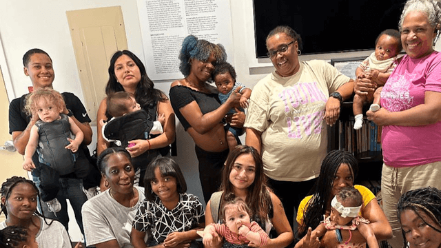 A group of YoungLives mothers and leaders alongside Adriene Perry (center, right)