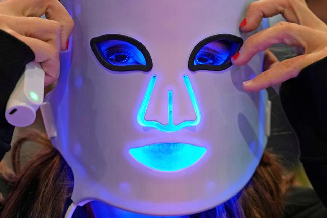 Representative for a light therapy mask company demonstrates one of the devices during the CES tech show