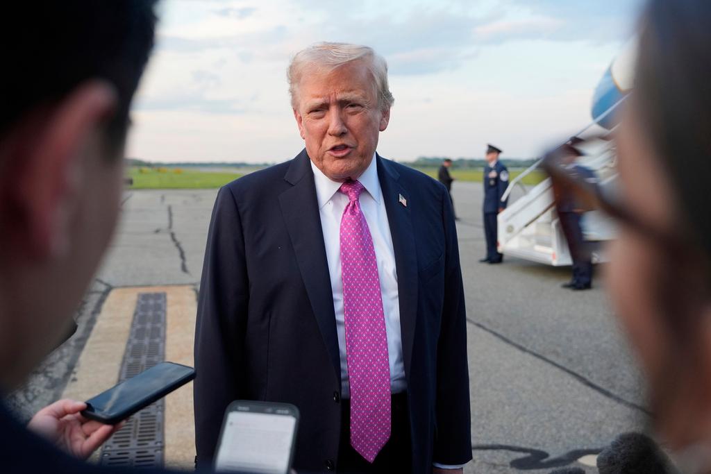 President Donald Trump speaks with reporters before boarding Air Force One 