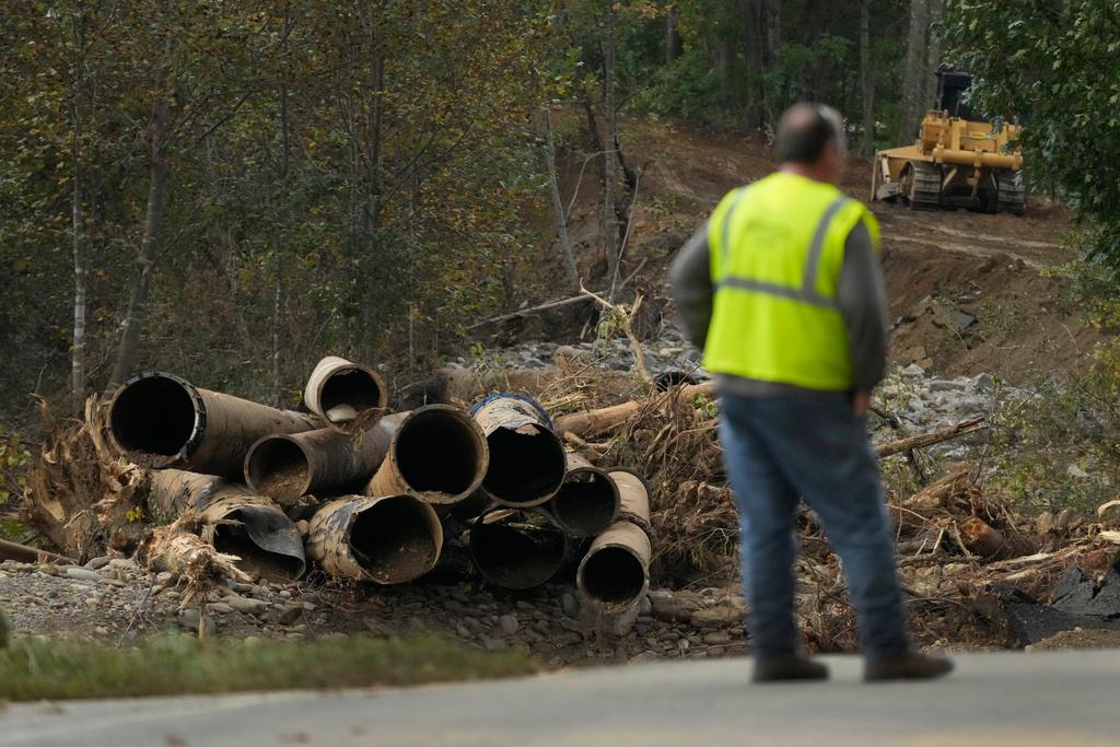 Electrical contract worker Matthew Tipton looks over the remnants of a waterline serving Asheville, N.C., downstream from North Fork Reservoir, a main source of water for the city