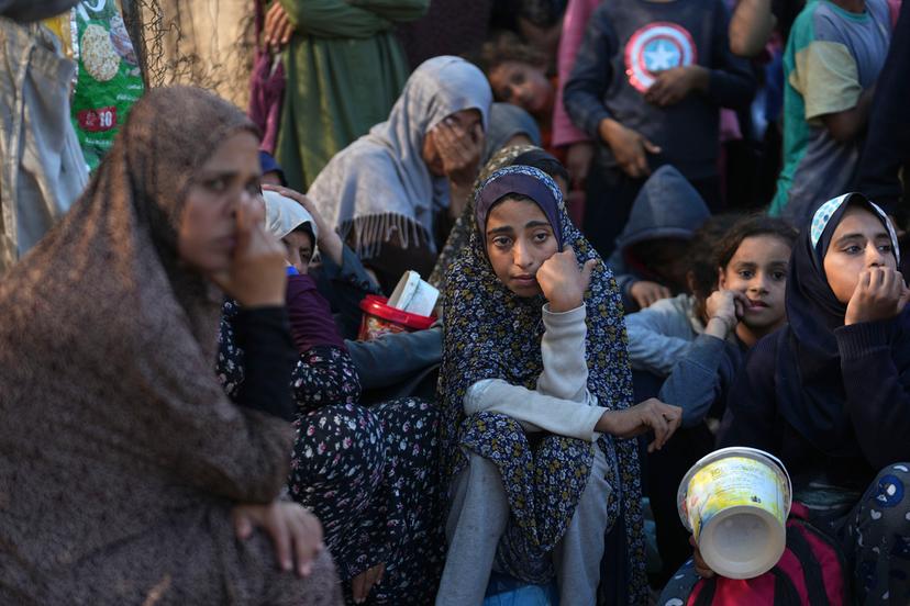 Palestinians queue for food in Deir al-Balah, Gaza Strip, Monday, Nov. 18, 2024. 