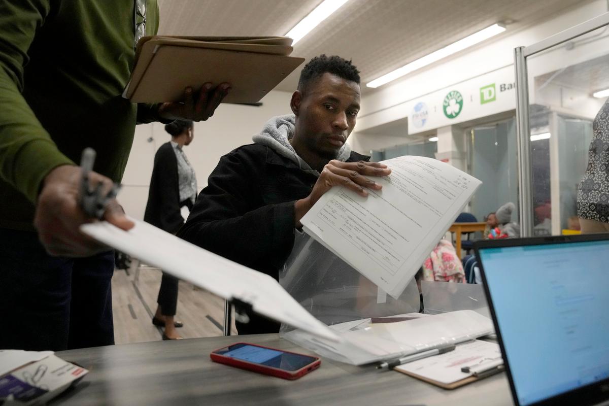 Man in immigration office with paperwork