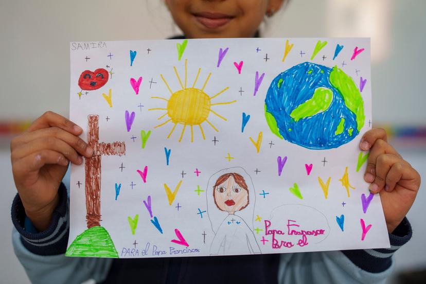 Samira, 8, shows s a picture reading in Spanish: "For the Pope Francisco" as part of an initiative to encourage Pope Francisco in his recovery, with the drawings to be sent to him as a sign of affection at Beata Maria Jesus School 