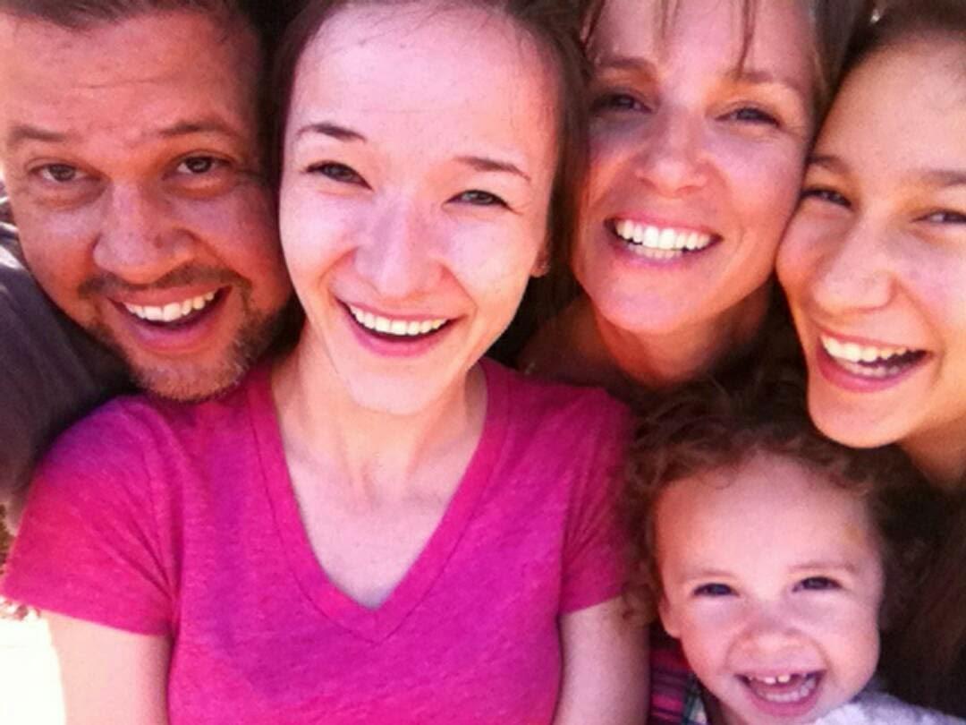 Five family members, smiling close up