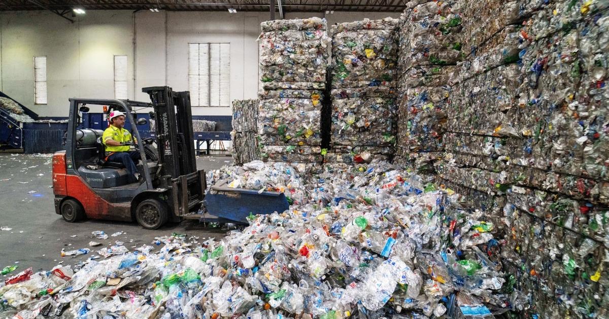 piles of crushed plastic bottles in a warehouse