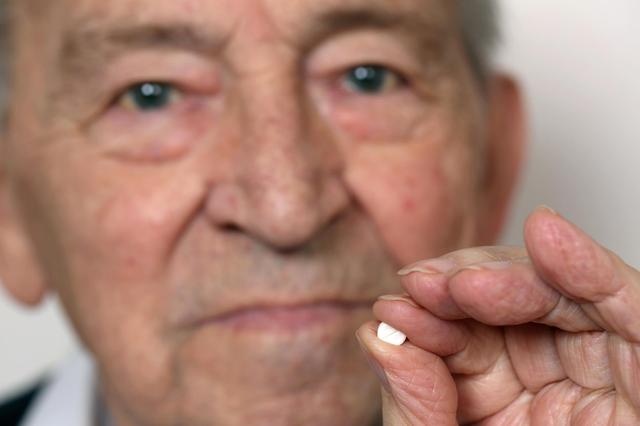 man holds pill